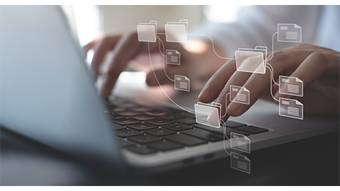 Document Management System (DMS) being setup by IT consultant working on laptop computer in office with document directory. Software for archiving, searching and managing corporate file information | Image Credit: Adobe Stock Images/tippapatt